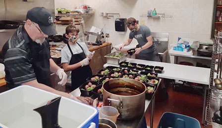 Orillia Club members working in a kitchen